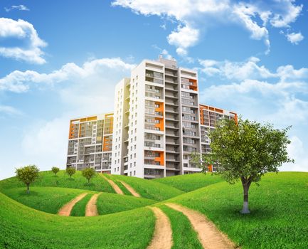 Tall buildings, green hills and road against sky with clouds. Architectural concept