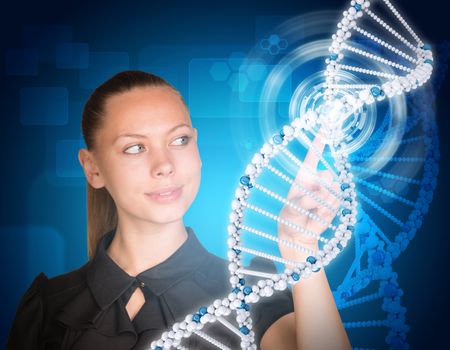 Beautiful businesswoman in dress smiling and presses finger on model of DNA. Scientific and medical concept