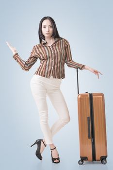 Modern Asian woman stand with a luggage.