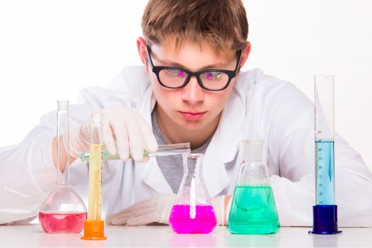 Young scientist doing chemical reactions in the laboratory - studio photo