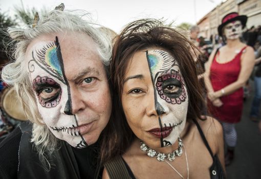 TUCSON, AZ/USA - NOVEMBER 09: Two unidentified people wearing facepaint at the All Souls Procession on November 09, 2014 in Tucson, AZ, USA.