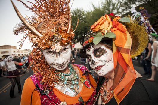 TUCSON, AZ/USA - NOVEMBER 09: Two undientified women in facepaint and costumes at the All Souls Procession on November 09, 2014 in Tucson, AZ, USA.