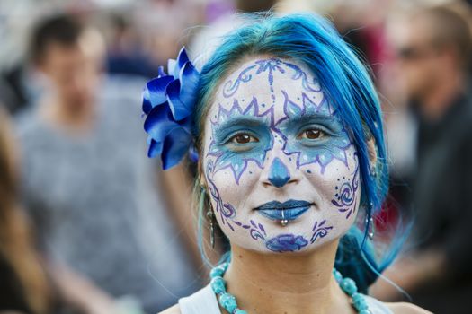 TUCSON, AZ/USA - NOVEMBER 09: Unidentified young woman in blue facepaint at the All Souls Procession on November 09, 2014 in Tucson, AZ, USA.