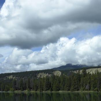 Sandy mountain with trees and lake