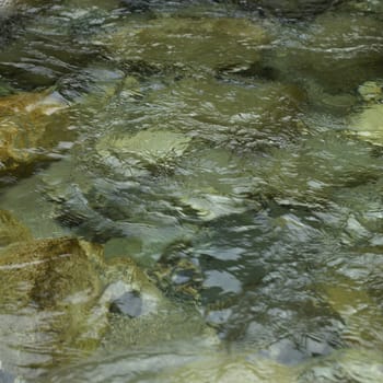 Close up of a river with clear water and stones