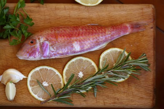 red mullet and lemon on wooden table