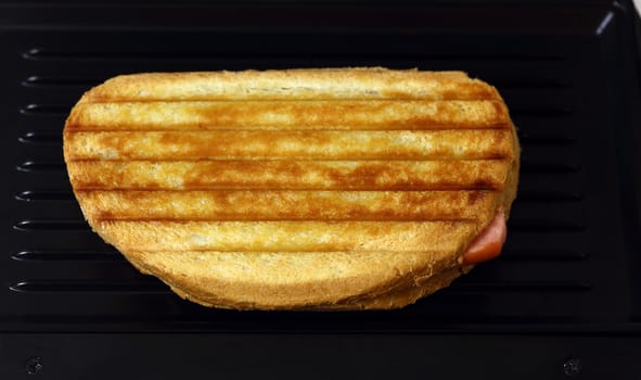 Sandwich toaster with toast close up