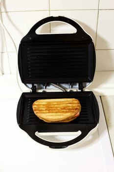 Sandwich toaster with toast close up