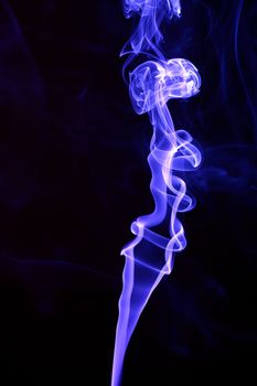 Abstract smoke trails on black background.