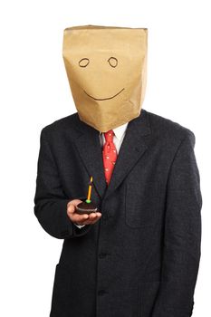 Businessman with paper bag on his head celebrating a birthday 