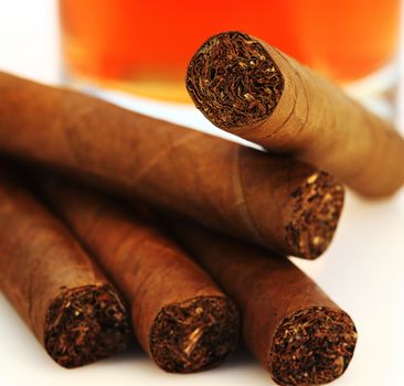 A pile of aromatic cigars close up shallow dof