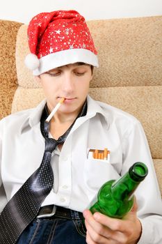 Teenager in Santa Hat with Bottle of the Beer smoking Cigarette