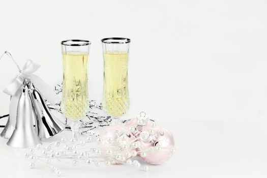 Two wine glasses with silver bells and copy space