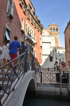 Lots of tourists walking by the streets of Venice, Italy