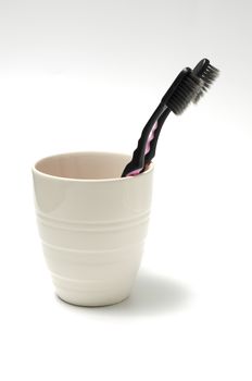 tooth brush in glass on a white background