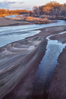 winter sunset over sandbars and meanders of the South Platte River in eastern Colorado