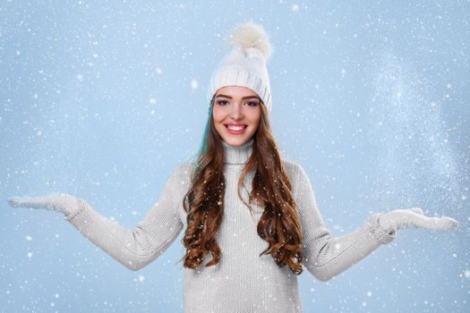 Winter. Cute girl during snowfall