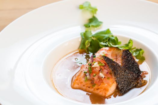 fish soup in white plate. selective focus