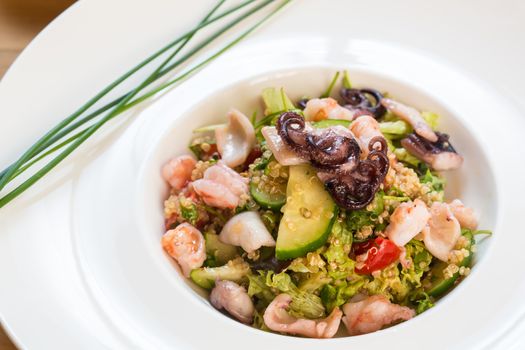 organic seafood salad with quinoa. selective focus