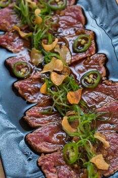 Beef Carpaccio on dark background. selective focus