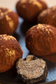 delicious chocolate truffles with golden. Selective focus