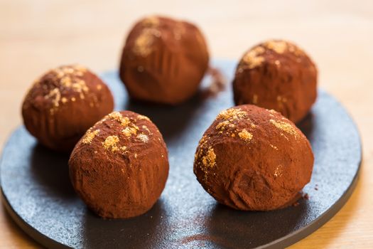 delicious chocolate truffles with golden. Selective focus