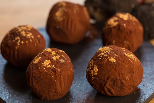 delicious chocolate truffles with golden. Selective focus