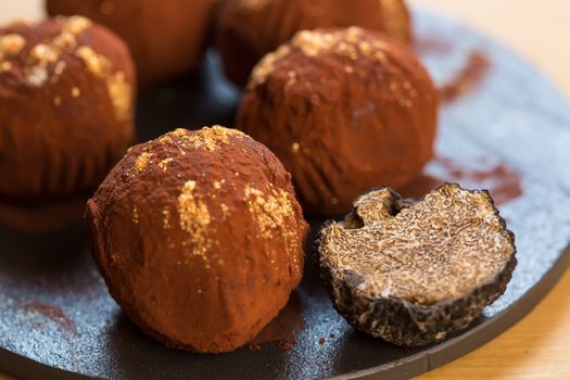 delicious chocolate truffles with golden. Selective focus