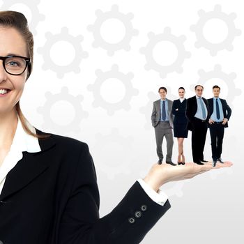 Business team standing together on woman's palm