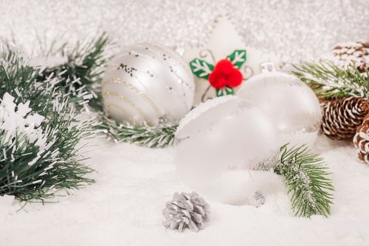 Beautiful Christmas balls decoration on shiny silver background. Shallow depth of field
