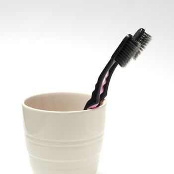 tooth brush in glass on a white background