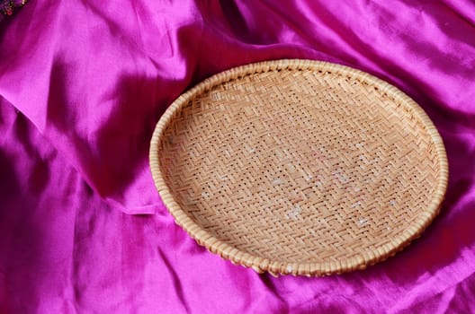 empty basket on the pink satin