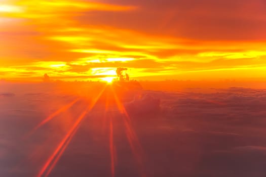 Sunset with clouds over view from airplane flying