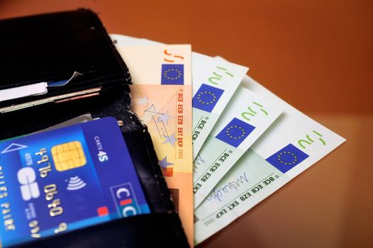open wallet with credit cards and euro to illustrate the personal economy and the purchasing power