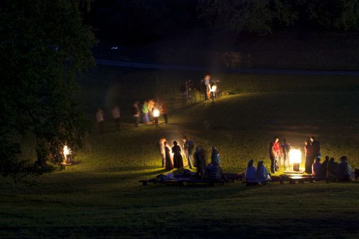 People celebrate summer solstice night around a bonfires in Latvian village. Midsumer or John's eve celebration around a bonfire is reminiscent of Midsummer's pagan rituals and very popular in Latvia.