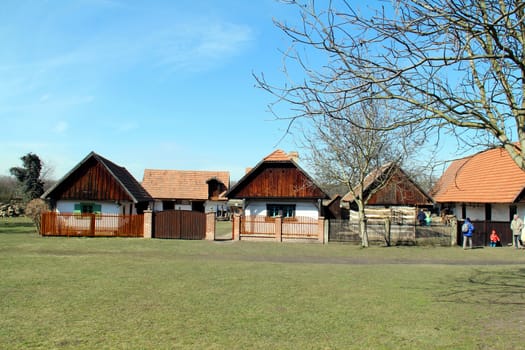 Photo shows old village houses and their surroundings..