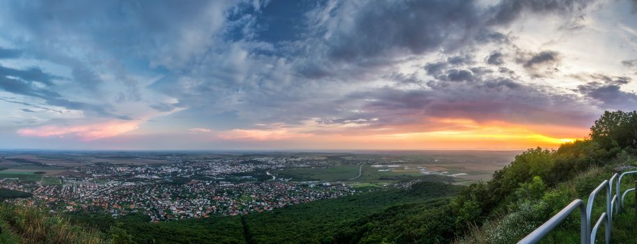 City of Nitra from Above at Sunset with Plants and Railings in Foreground as Seen from Zobor Mountain