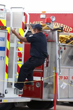 SMITHS FALLS, ON, CANADA - AUGUST 23, 2014.  A fireman is on site at the third annual Race the Runway event held at the Russ Beach Airport, in Smiths Falls, Ontario, Canada, on August 23, 2014.