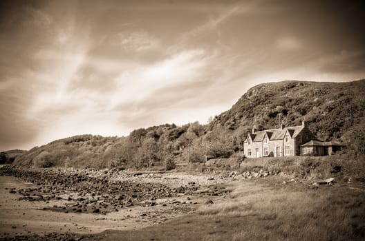 Retro Style Sepia Photo Of A House By Sea In The Countryside