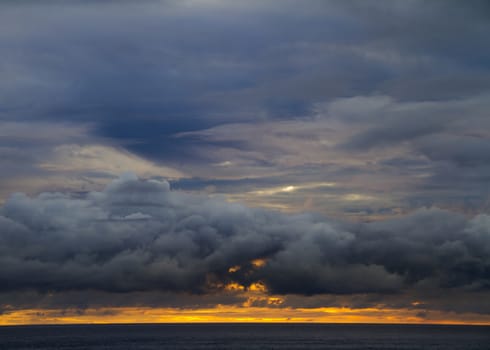 A beautiful sunrise at dawn golden sky and storm clouds