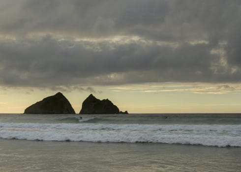 surfer at sunset,  holywell bay, newquay UK