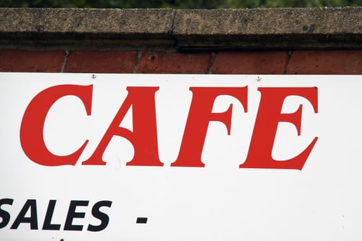 Cafe sign on a wall close up