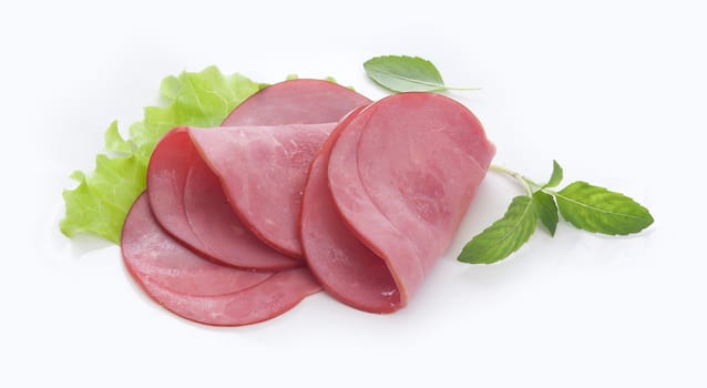 Three pieces of beef sausages cuts with green lettuce on the white