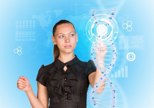 Young girl looks at model of DNA and presses her finger. Scientific and medical concept