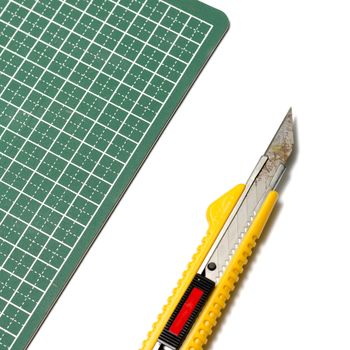 cutter knife on cutting board on a white background