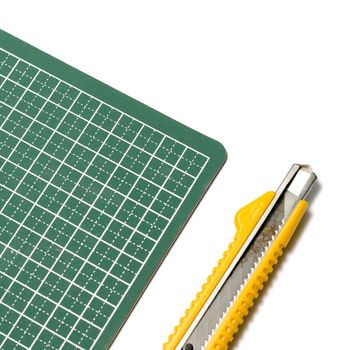 cutter knife on cutting board on a white background