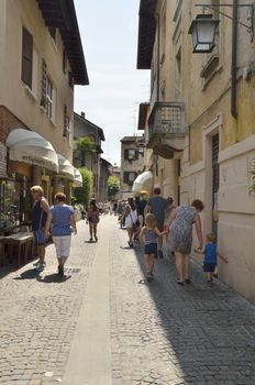 People walking by the streets in Sirmione on lake Garda, Italy. 