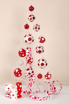 Composition in the form of a New Year tree, candles and red-white spheres