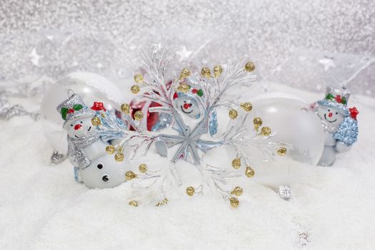 Cheerful snowman and Christmas tree decorations. Winter background. High key  with shallow depth of field