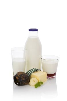 Milk, yogurt and butter. Traditional dairy products high in calcium with traditional austrian cow bell isolated on white background. 